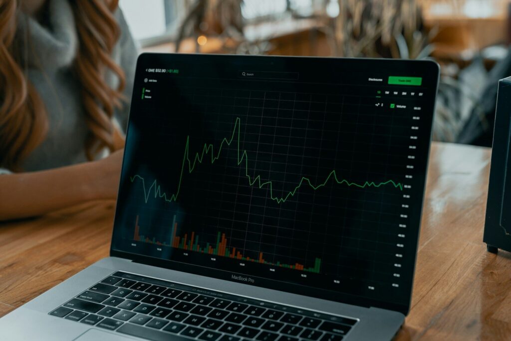 laptop showing stock chart on desk