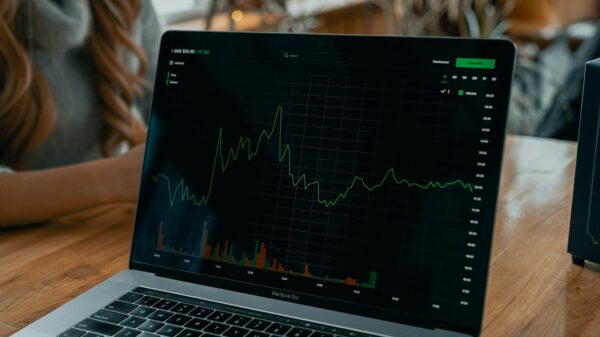 laptop showing stock chart on desk
