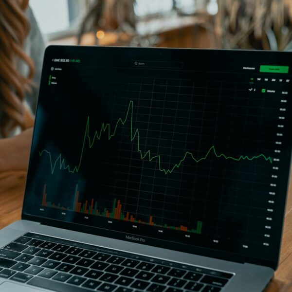 laptop showing stock chart on desk